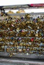 Numerous Ã¢â¬ÅLove locksÃ¢â¬Â attached to a pedestrian bridge across Seine river, Paris